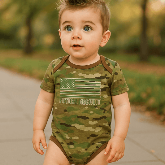 Baby Multicam Future Recruit Bodysuit on a flat surface, showcasing camouflage pattern and infant clothing design.
