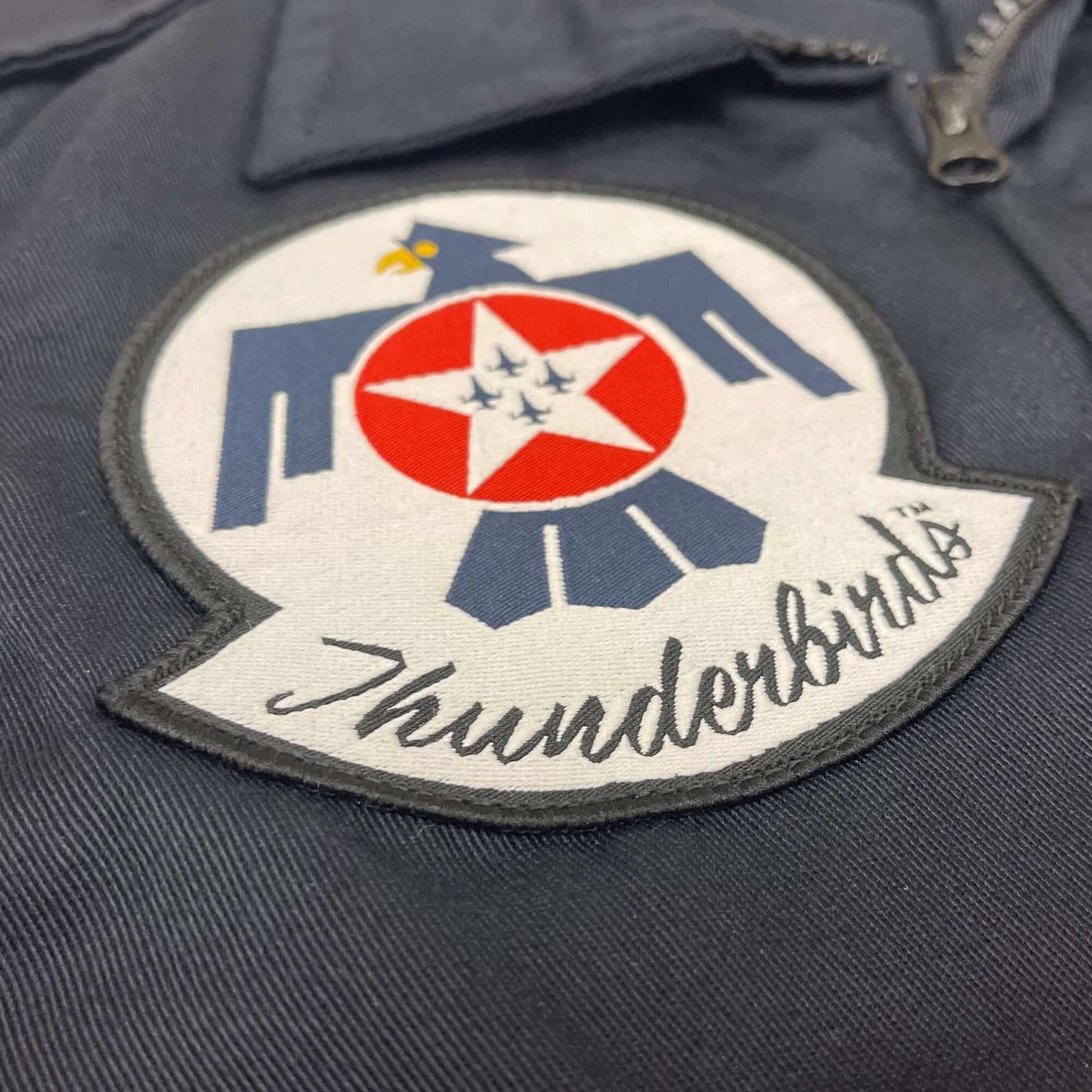 Embroidered Thunderbirds patch on a durable flight suit, showcasing the eagle and star design.