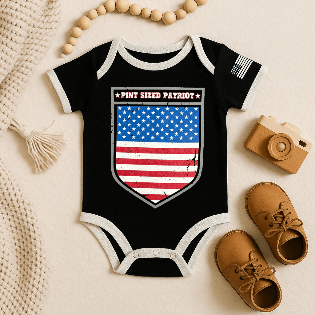 Baby bodysuit featuring distressed American Flag shield and text 'PINT SIZED PATRIOT' on a black background.