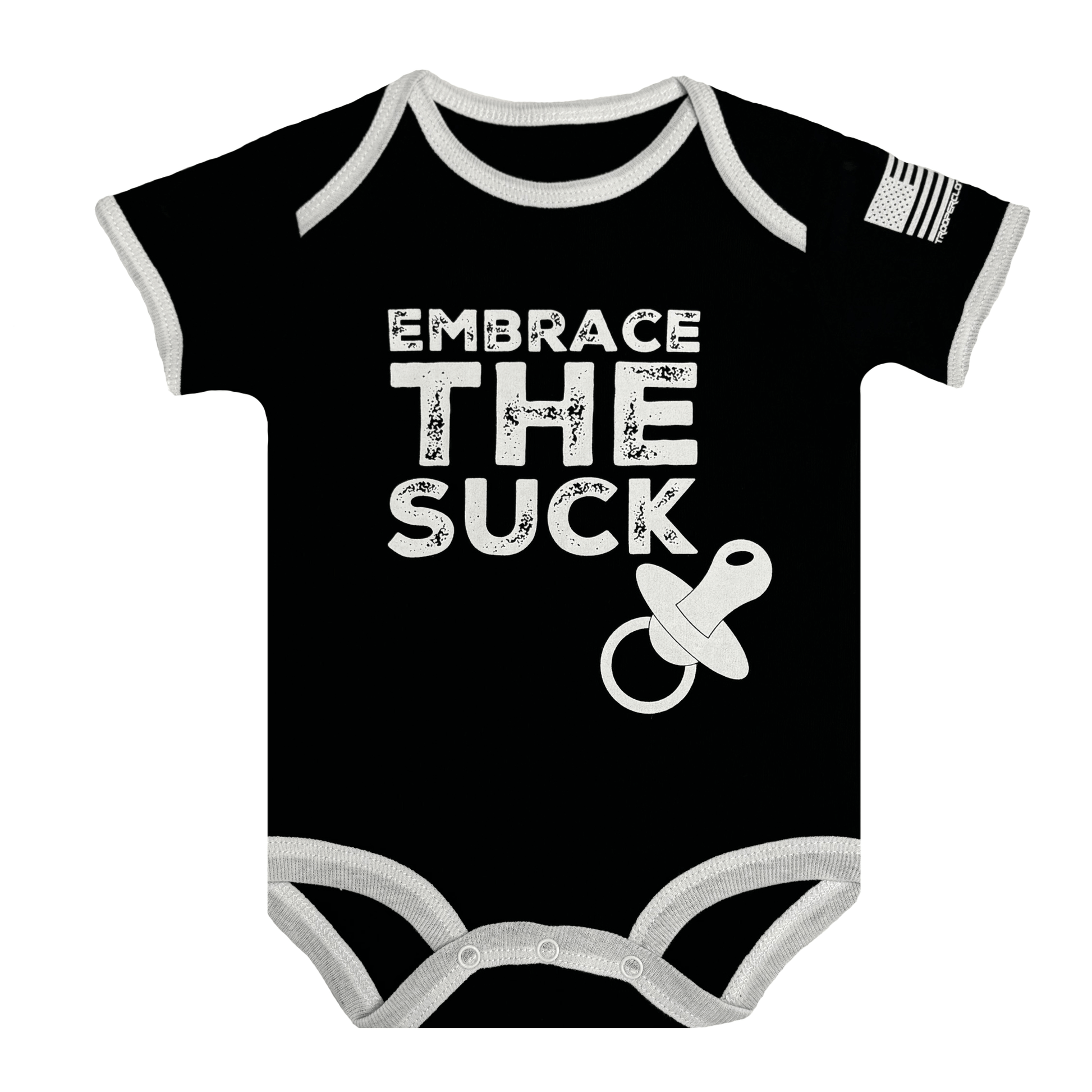 Baby bodysuit with black fabric, white text saying 'Embrace The Suck' and American flag sleeve.