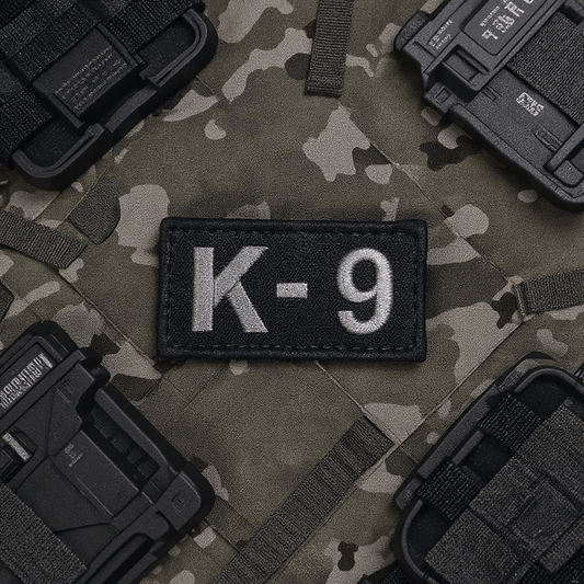 Embroidered Patch K-9 by Trooper Clothing on camo vest, featuring light gray stitching and hook and loop backing.