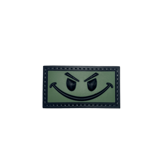 Patch OD Green and Black Smiley PVC with hook-and-loop backing, perfect for enhancing your gear.