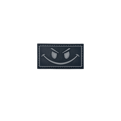 Patch Black and Gray Smiley PVC badge measuring 2 3/8" x 1 1/4" with hook-and-loop backing.