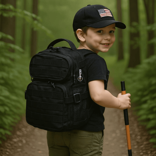Youth wearing a black tactical backpack while hiking in the woods, showcasing a stylish backpack for kids.