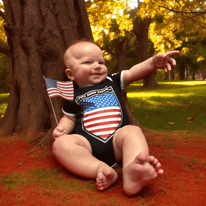 Baby wearing a Pint Sized Patriot bodysuit with American flag, sitting outdoors with fall foliage.